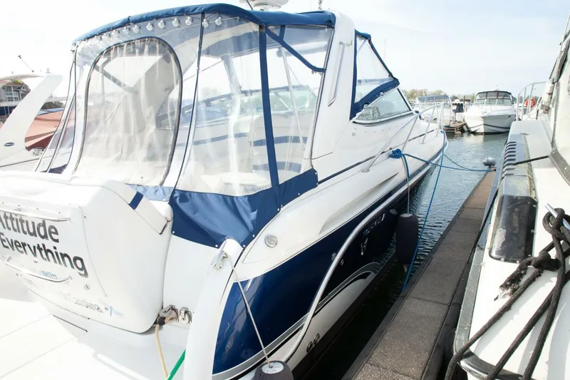 Slide: The Image of A white and blue motor yacht docked, featuring a transparent canopy and well-maintained appearance. - 6