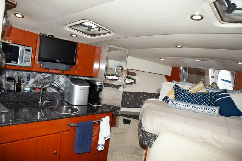 Slide: The Image of Interior of a 2006 Formula 31 Performance Cruiser with kitchen, bed, and TV. - 18