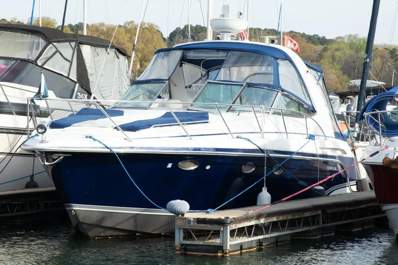 Slide: The Image of A blue 2006 Formula 31 Performance Cruiser docked, surrounded by other boats. - 1