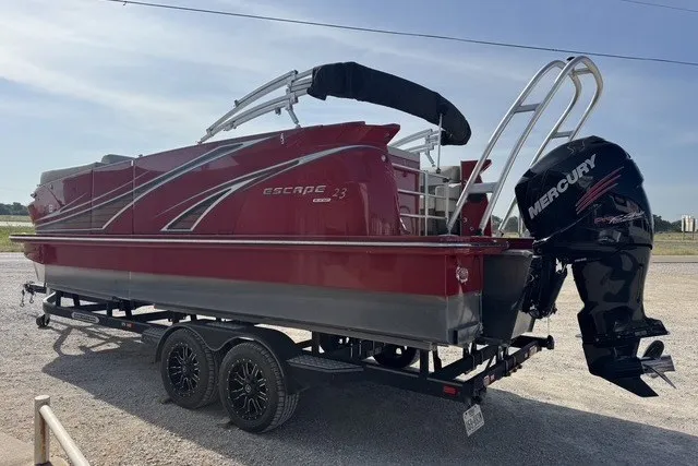 Slide: The Image of 2018 Larson Escape 23 Triple TTT boat with Mercury engine on trailer. - 4