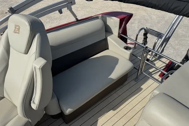 Slide: The Image of 2018 Larson Escape 23 Triple TTT boat interior with beige seating and cup holder. - 8