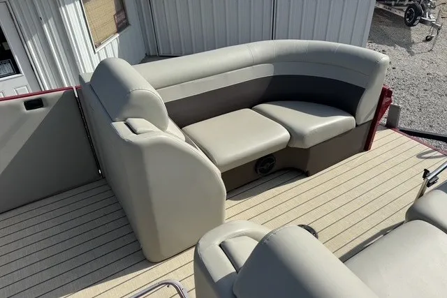 Slide: The Image of 2018 Larson Escape 23 Triple TTT boat interior with beige seating and spacious deck. - 14