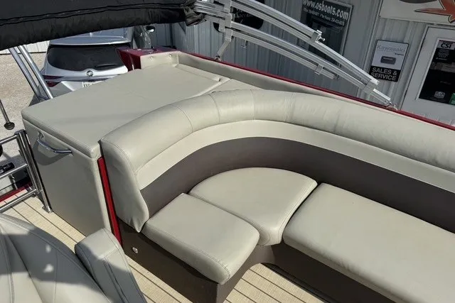 Slide: The Image of 2018 Larson Escape 23 Triple TTT boat interior with beige seating and modern design. - 9