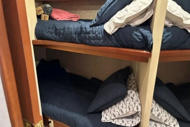 Slide: The Image of Bunk beds in 2006 Silverton 34 Convertible yacht cabin with blue bedding. - 18