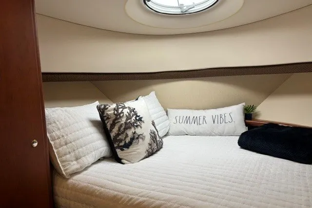 Slide: The Image of Cozy cabin interior of 2006 Silverton 34 Convertible with decorative pillows and bedding. - 16