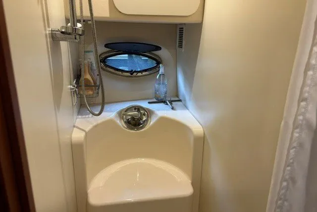 Slide: The Image of Compact bathroom in 2006 Silverton 34 Convertible yacht with shower and porthole. - 15