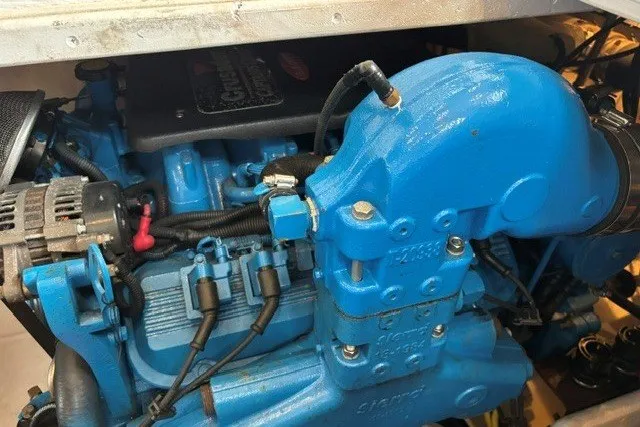 Slide: The Image of Engine of a 2006 Silverton 34 Convertible boat, featuring a vibrant blue color. - 26
