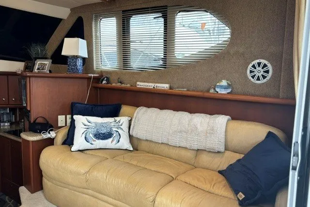 Slide: The Image of Interior of 2006 Silverton 34 Convertible with beige sofa and nautical decor. - 7