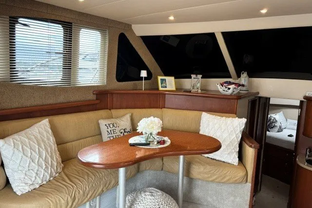 Slide: The Image of Interior of 2006 Silverton 34 Convertible yacht with cozy seating and elegant decor. - 6