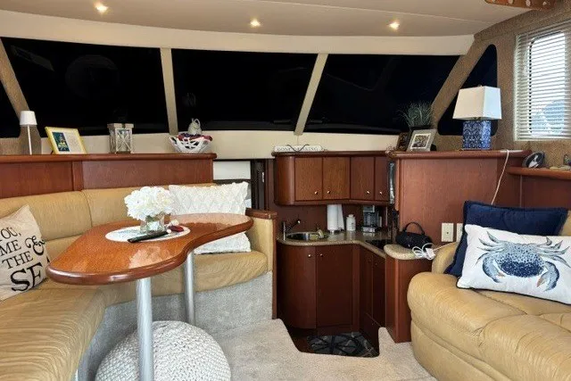 Slide: The Image of Interior of a 2006 Silverton 34 Convertible yacht with cozy seating and elegant decor. - 5