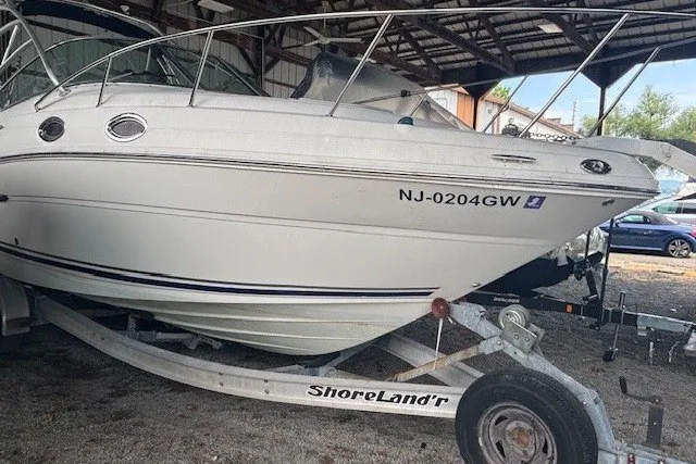 The Image of 2005 Sea Ray 270 Amberjack boat on ShoreLand'r trailer in storage facility. - 0