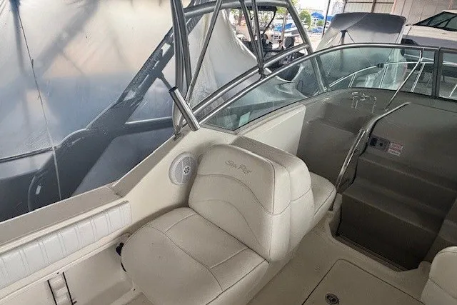 Slide: The Image of 2005 Sea Ray 270 Amberjack boat interior with white seating and helm station. - 5