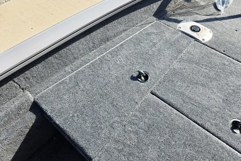 Slide: The Image of Interior view of 2027 Tracker Pro Team 175 Crappie Edition boat, featuring gray carpeted flooring. - 29