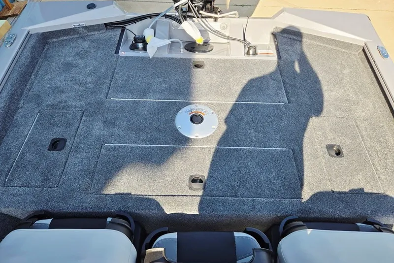 Slide: The Image of 2027 Tracker Pro Team 175 Crappie Edition boat deck with carpeted surface and storage compartments. - 16