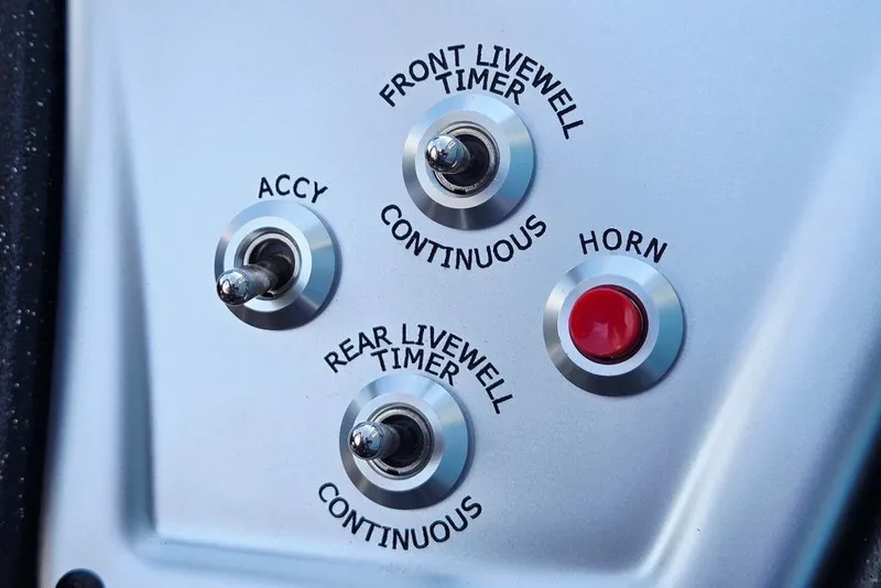 Slide: The Image of Control panel of 2027 Tracker Pro Team 175 Crappie Edition boat with switches and horn button. - 43