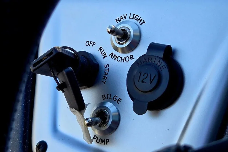Slide: The Image of Control panel of 2027 Tracker Pro Team 175 Crappie Edition boat with switches and 12V outlet. - 23
