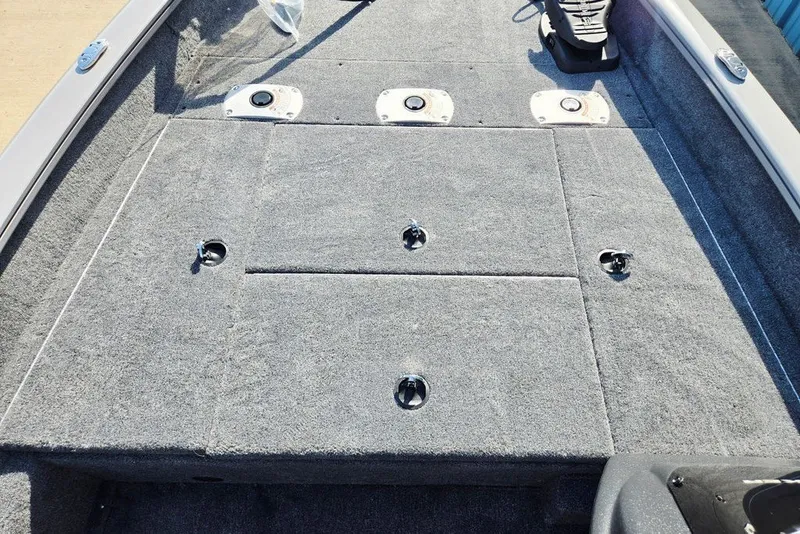 Slide: The Image of 2027 Tracker Pro Team 175 Crappie Edition boat deck with carpeted surface and storage compartments. - 15