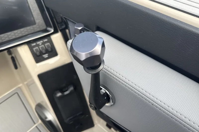 Slide: The Image of Close-up of a boat throttle lever in a 2027 MasterCraft NXT23. - 16