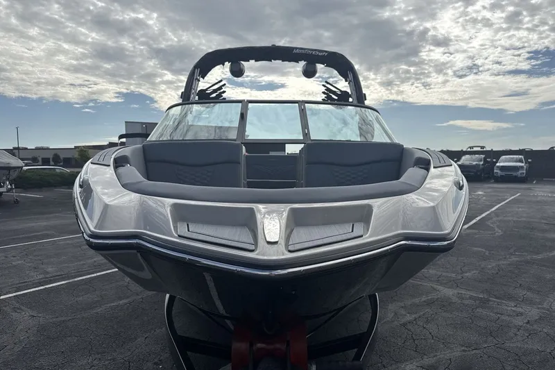 Slide: The Image of A modern MasterCraft NXT23 from 2027 is parked under a cloudy sky. - 8