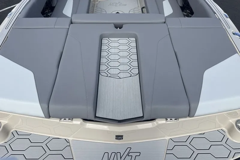Slide: The Image of The image shows the stern of a MasterCraft NXT23 boat with gray upholstery and a modern design. - 19