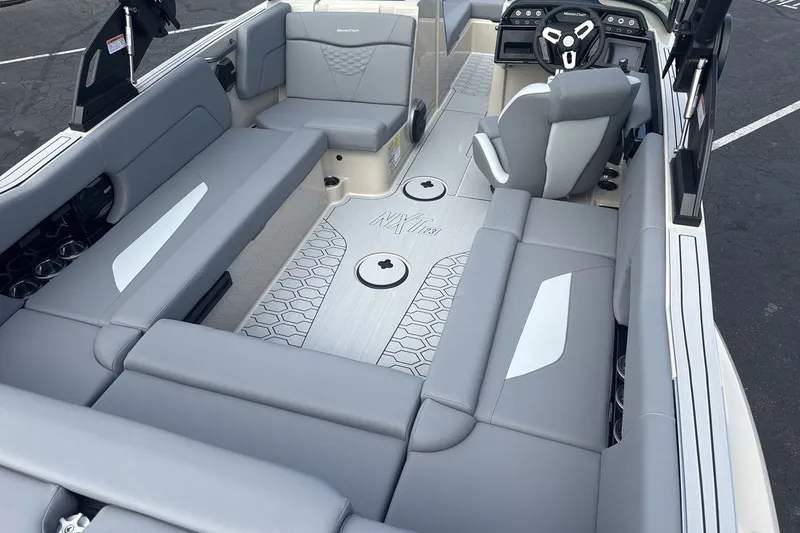 Slide: The Image of The image shows the interior of a 2027 MasterCraft NXT23 boat with gray upholstery and modern design. - 10
