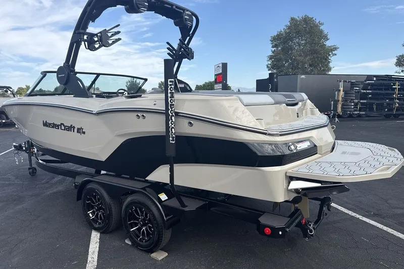 Slide: The Image of A 2027 MasterCraft NXT23 on a trailer. It features a modern design and a platform. - 3