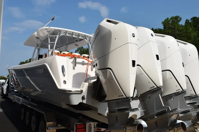 Slide: The Image of 2027 Contender 44 ST boat with multiple powerful outboard engines on a trailer. - 6