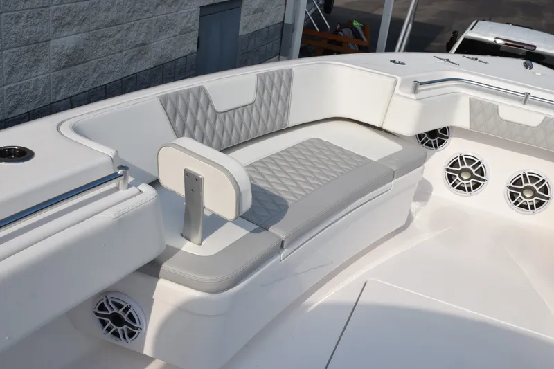 Slide: The Image of 2027 Contender 44 ST boat interior with white and gray seating, featuring built-in speakers. - 23