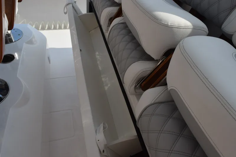 Slide: The Image of Luxury seating on 2027 Contender 44 ST boat with quilted upholstery and storage compartment. - 45