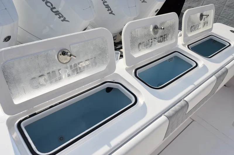 Slide: The Image of Livewell compartments on a 2027 Contender 44 ST boat, featuring Mercury engines. - 53