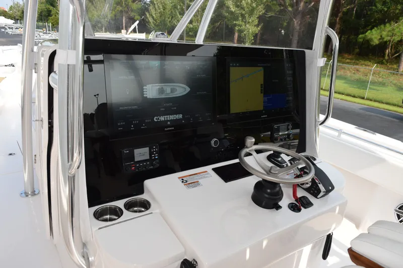 Slide: The Image of 2027 Contender 44 ST boat dashboard with advanced navigation system and steering wheel. - 15