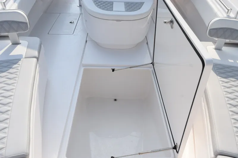 Slide: The Image of Contender 44 ST 2027 boat interior with open storage compartment and cushioned seating. - 33