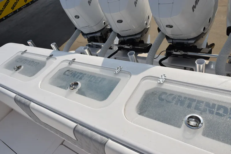 Slide: The Image of 2027 Contender 44 ST boat with triple outboard engines and livewell compartments. - 52