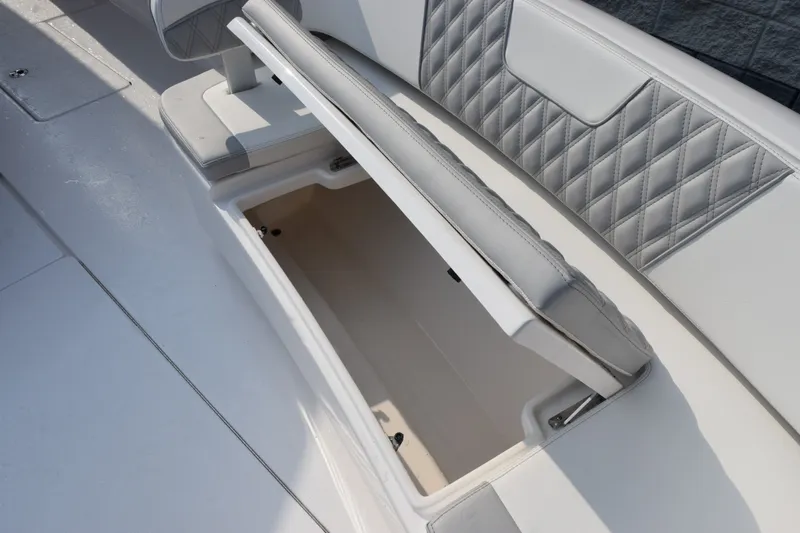 Slide: The Image of 2027 Contender 44 ST boat seat with open storage compartment, featuring quilted upholstery. - 35