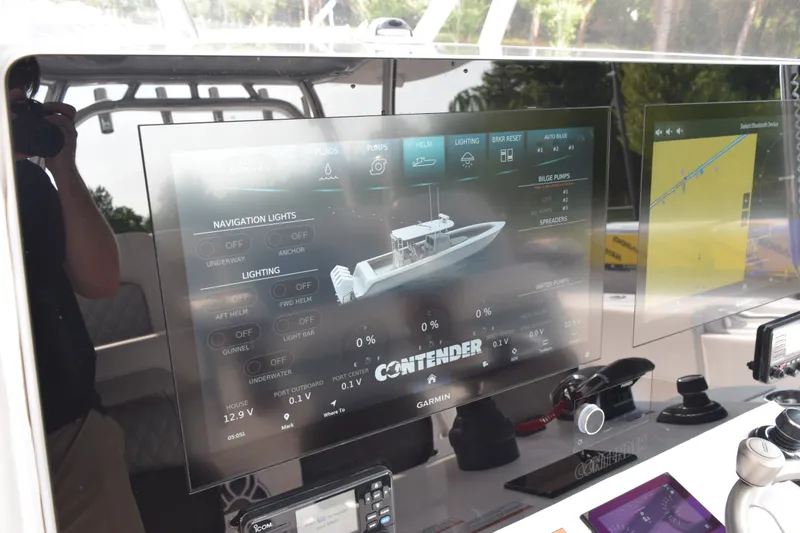 Slide: The Image of Dashboard of 2027 Contender 44 ST boat with navigation and lighting controls. - 44