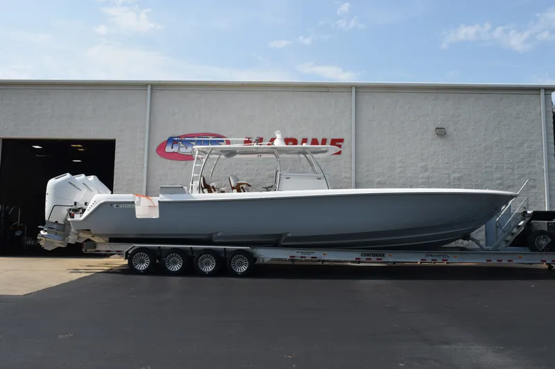 The Image of 2027 Contender 44 ST boat on trailer outside marine facility. - 1