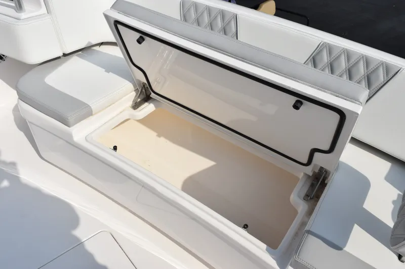 Slide: The Image of Open storage compartment on 2027 Contender 44 ST boat with cushioned seating. - 14