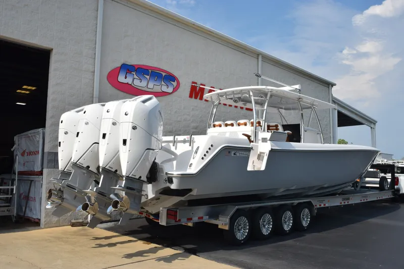 Slide: The Image of 2027 Contender 44 ST boat with triple engines on a trailer outside GSPS Marine. - 4