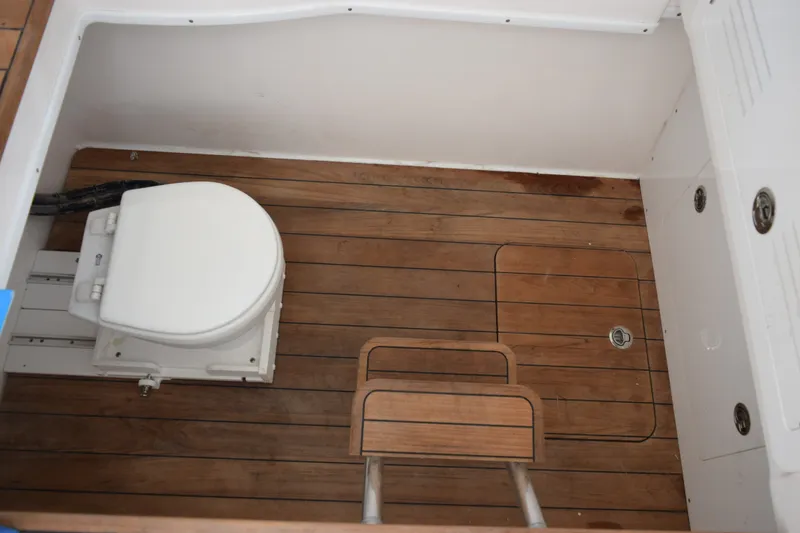 Slide: The Image of Contender 44 ST 2027 boat interior with wooden flooring and marine toilet. - 30