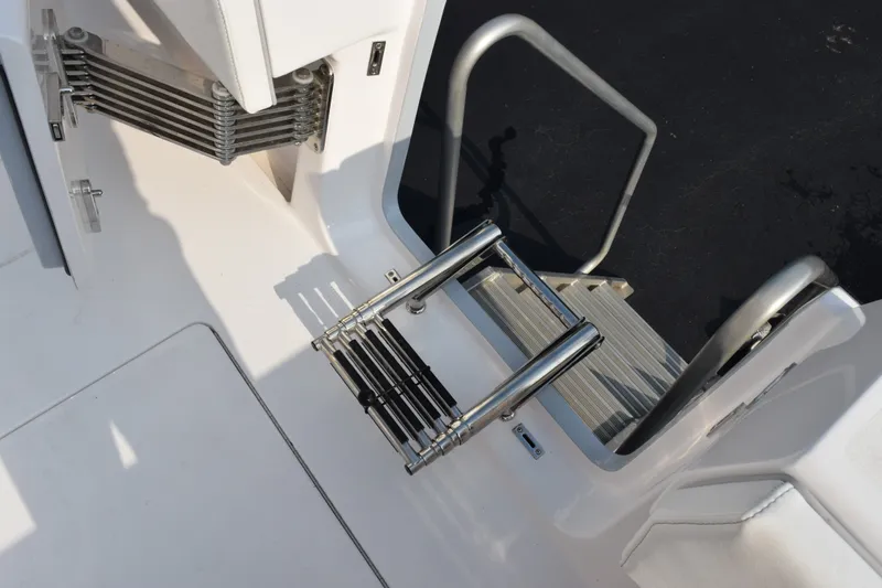 Slide: The Image of Contender 44 ST 2027 boat ladder and deck area, featuring stainless steel components. - 51