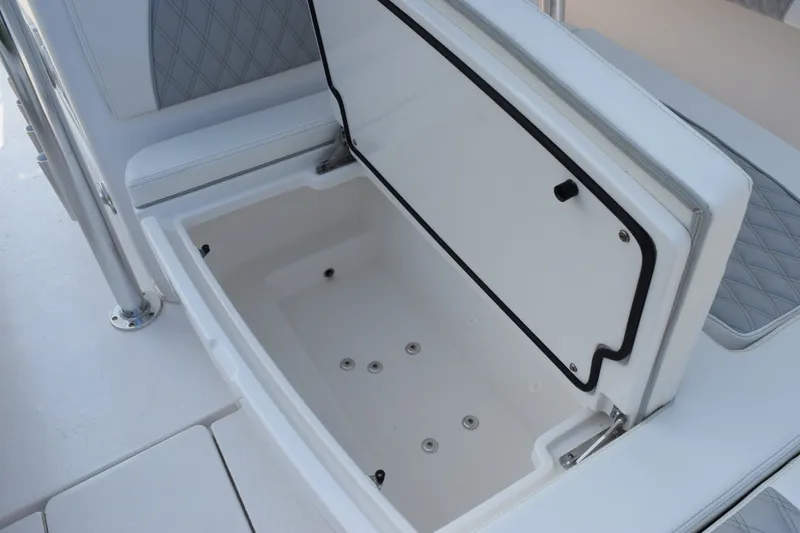 Slide: The Image of Open storage compartment on 2027 Contender 44 ST boat, featuring sleek white interior design. - 37