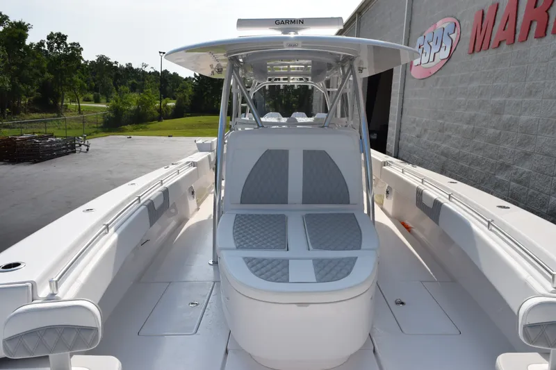 Slide: The Image of 2027 Contender 44 ST boat with sleek seating and Garmin equipment, docked near a marine facility. - 12