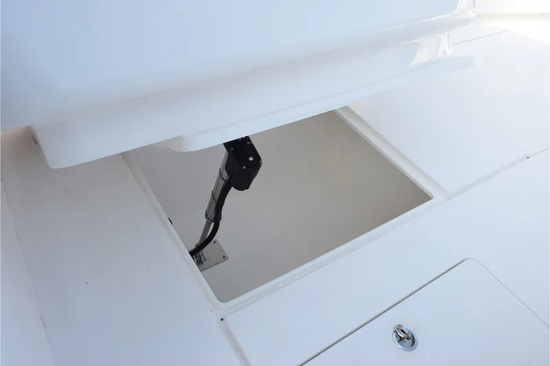 Slide: The Image of Open hatch on 2027 Contender 44 ST boat deck, revealing interior compartment. - 55