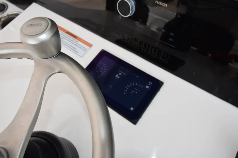 Slide: The Image of Steering wheel and dashboard of 2027 Contender 44 ST boat with digital display. - 42