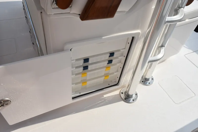 Slide: The Image of Storage compartment on 2027 Contender 44 ST boat with open door and organized trays. - 46