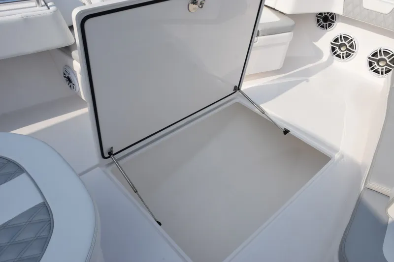 Slide: The Image of Contender 44 ST 2027 boat interior with open storage compartment and speakers. - 32