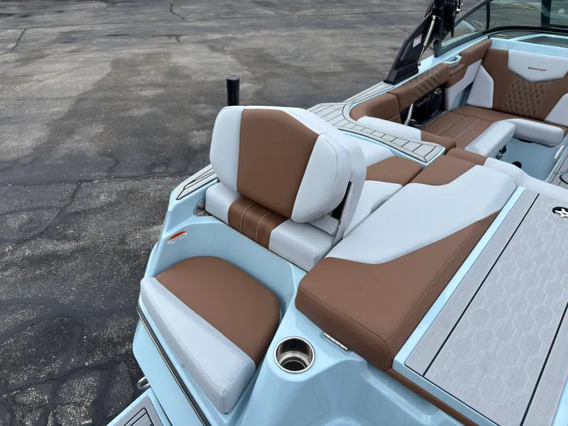 Slide: The Image of The image shows the luxurious interior of a MasterCraft XT20 boat with brown and white seating. - 12