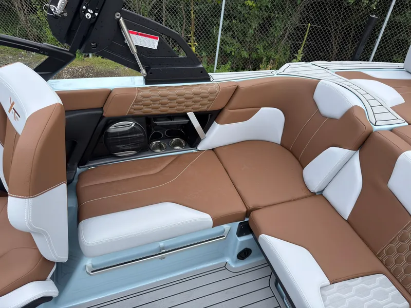 Slide: The Image of The image shows the luxurious interior of a 2027 MasterCraft XT20 with brown and white seating. - 23