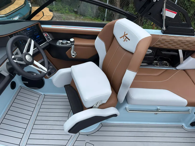 Slide: The Image of Interior of a 2027 MasterCraft XT20 with brown and white seats and a modern dashboard. - 34