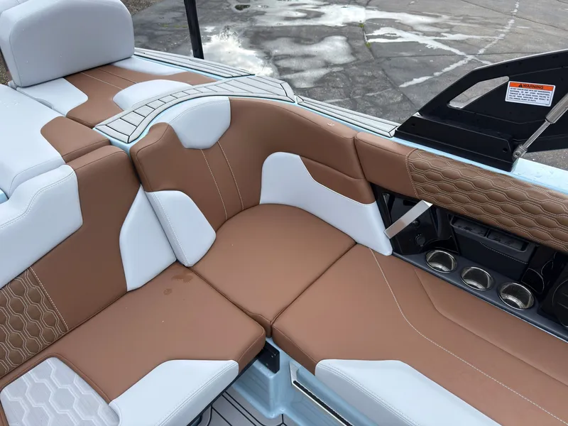Slide: The Image of The 2027 MasterCraft XT20 features luxurious two-tone upholstery in brown and white. - 25